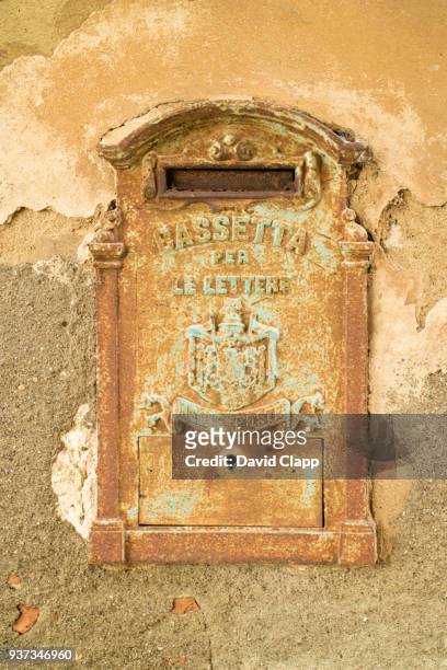 ancient postbox in lucignano d'asso in tuscany, italy - lucignano d'asso stock pictures, royalty-free photos & images