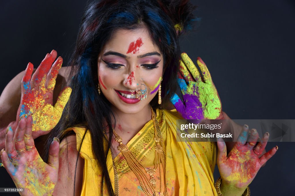 Indian woman celebrating Holi.