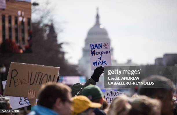 Participants take part in the March for Our Lives Rally in Washington, DC on March 24, 2018. - Bundled against the cold but fired up with passion...
