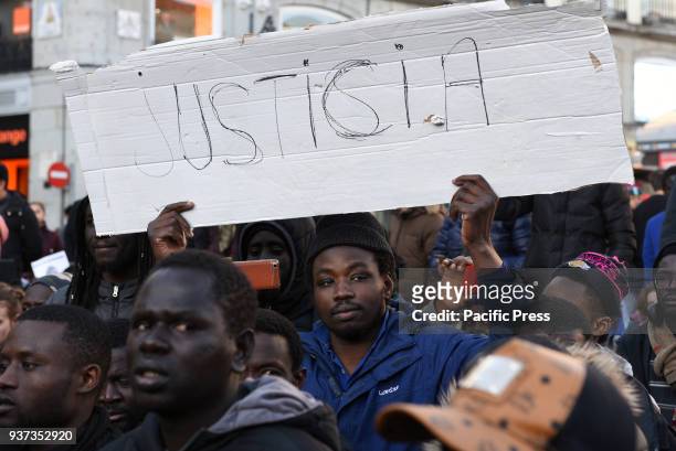 Man holds a banner with the message 'Justicia' as he takes part a protest in Madrid in memory of the Senegalese street vendor Mame Mbaye. Around 250...