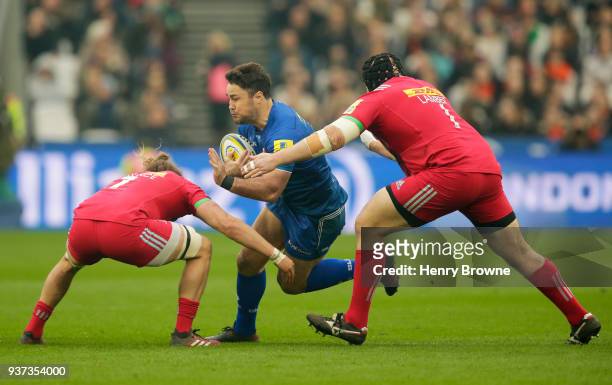 Brad Barritt of Saracens tackled by Luke Wallace of Harlequins and Mark Lambert of Harlequins during the Aviva Premiership match between Saracens and...