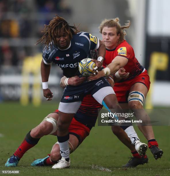 Marland Yarde of Sale Sharks breaks through the tackle of David Denton of Worcester Warriors during the Aviva Premiership match between Sale Sharks...