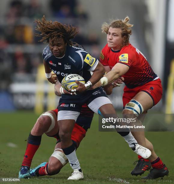 Marland Yarde of Sale Sharks breaks through the tackle of David Denton of Worcester Warriors during the Aviva Premiership match between Sale Sharks...