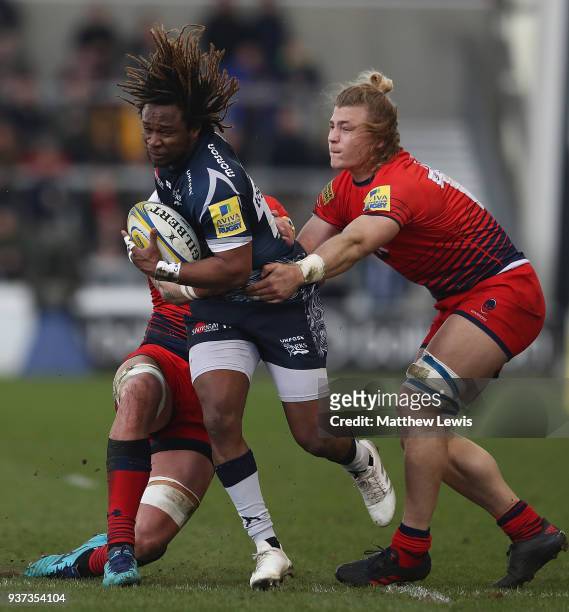 Marland Yarde of Sale Sharks breaks through the tackle of David Denton of Worcester Warriors during the Aviva Premiership match between Sale Sharks...