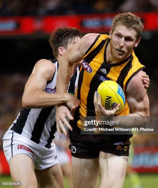 Ben McEvoy of the Hawks is tackled by Josh Thomas of the Magpies during the 2018 AFL round 01 match between the Hawthorn Hawks and the Collingwood...