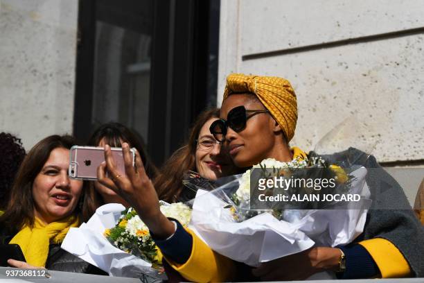 French singer and model Imany takes a selfie with French journalist and actress Sonia Dubois as they take part in the fifth annual worldwide...