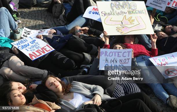 Demonstrators lay on the ground in protest at the March for our Lives demonstration on March 24, 2018 in Berlin, Germany. The protest in Berlin was...