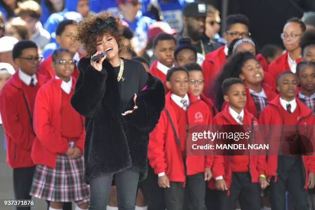 Singer Andra Day sings as people gather at the March for Our Lives Rally in Washington, DC on March 24, 2018. Galvanized by a massacre at a Florida...