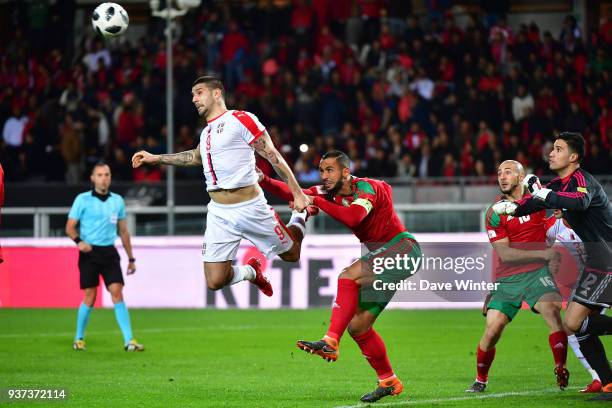 Aleksandar Mitrovic of Serbia, Medhi Benatia of Morocco and goalkeeper Munir Mohamedi Elkajoui of Morocco all miss the ball during the international...