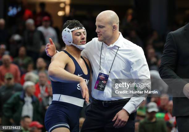 Head coach Cael Sanderson of the Penn State Nittany Lions congratulates Vincenzo Joseph winning the 165 pound championship during session six of the...