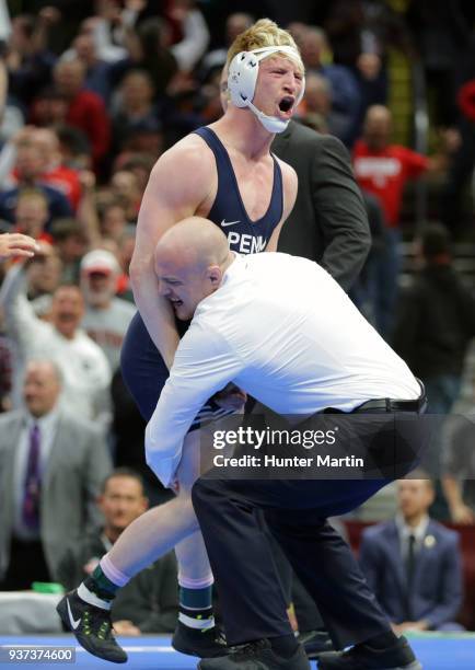 Bo Nickal of the Penn State Nittany Lions celebrates with head coach Cael Sanderson after winning the 184 pound championship match during session six...