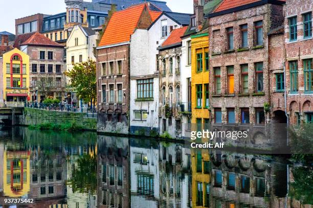 strolling through the canals of ghent, ghent, belgium - belgium stock-fotos und bilder