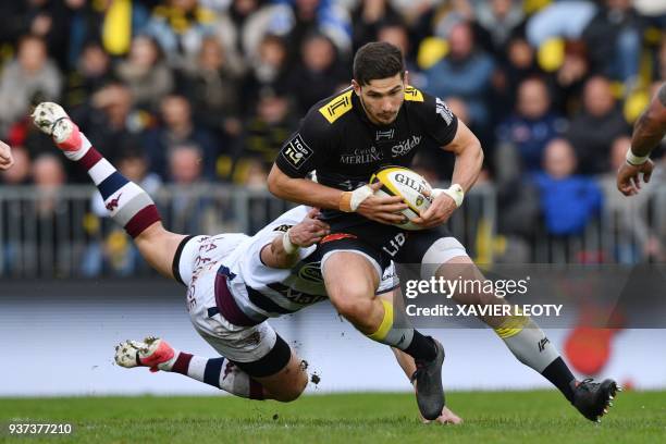 La Rochelle's South African center Paul Jordaan is tackled during the French Top 14 rugby union match between La Rochelle and Bordeaux-Begles on...