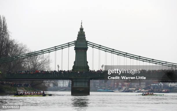 The Oxford and Cambridge University Women's Boat Club Blue crews pass under Hammersmith Bridge during The Cancer Research UK Womens Boat Race 2018...