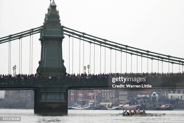 The Cambridge University Women's Boat Club Blue crew pass under Hammersmith Bridge during The Cancer Research UK Womens Boat Race 2018 on March 24,...