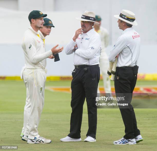 Umpires Nigel Llong and Richard Illingworth confront Australia's Cameron Bancroft during day three of the third Sunfoil Test match between South...