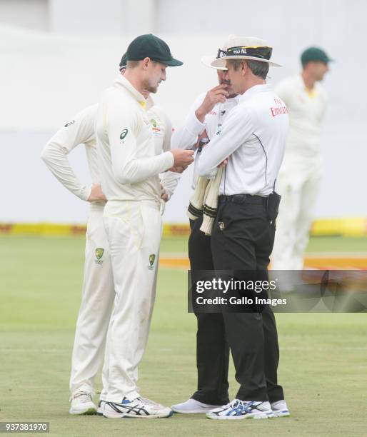 Umpires Nigel Llong and Richard Illingworth confront Australia's Cameron Bancroft during day three of the third Sunfoil Test match between South...