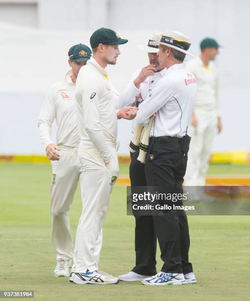 Umpires Nigel Llong and Richard Illingworth confront Australia's Cameron Bancroft during day three of the third Sunfoil Test match between South...