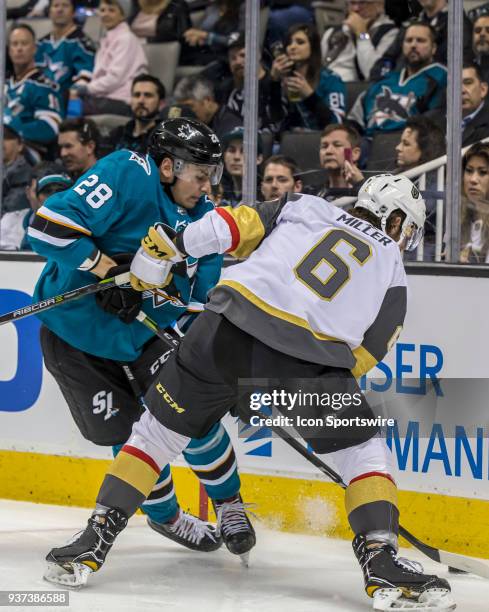 Vegas Golden Knights defenseman Colin Miller and San Jose Sharks right wing Timo Meier fight for the puck behind the Vegas Golden Knights net during...