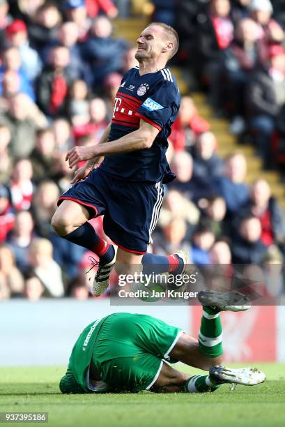 Alexander Zickler of Bayern Munich Legends clashes with David James of Liverpool Legends during the friendly match between Liverpool FC Legends and...