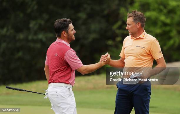 Ian Poulter of England shakes hands with Louis Oosthuizen of South Africa after defeating him 2&1 on the 17th green during the fourth round of the...