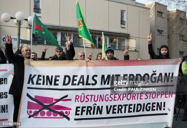 Protersters hold a giant banner reading "No deals with Erdogan, stop weapons export, Protect Afrin" during a demonstration of Kurdish groups to...