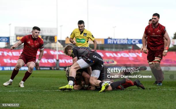Limerick , Ireland - 24 March 2018; James Hart of Munster scores his side's first try despite the efforts of Aled Davies and Will Boyde of Scarlets...