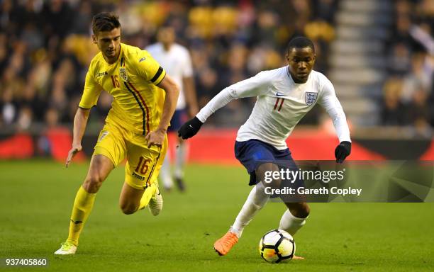 Ademola Lookman of England gets past Dragos Nedelcu of Romania during the International Friendly between England U21 and Romania U21 at Molineux on...