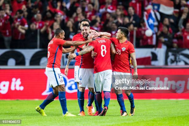 Arturo Vidal of Chile celebrates scoring the opening goal with teammates Angelo Sagal, Mauricio Isla, and Charles Aranguiz during an international...
