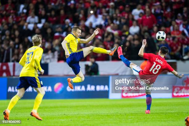 Sebastian Larsson of Sweden clears the ball away in mid air from Angelo Sagal of Chile during an international friendly between Sweden and Chile at...