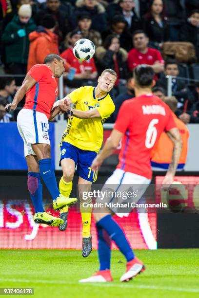 Jean Beausejour of Chile and Sebastian Larsson of Sweden battle for the ball in midair during an international friendly between Sweden and Chile at...