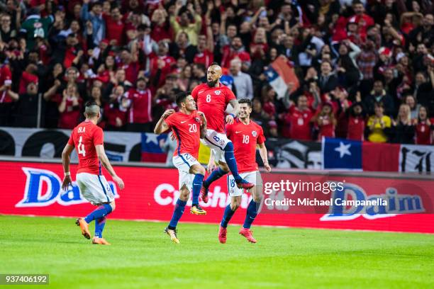 Arturo Vidal of Chile celebrates scoring the opening goal with teammates Angelo Sagal, Mauricio Isla, and Charles Aranguiz during an international...