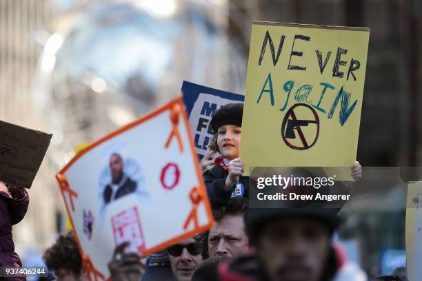 Young girl holds up a sign during the March For Our Lives in Manhattan, March 24, 2018 in New York City. Thousands of demonstrators, including...