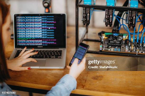 woman trading bitcoin price with a laptop computer by internet - binary code stock pictures, royalty-free photos & images