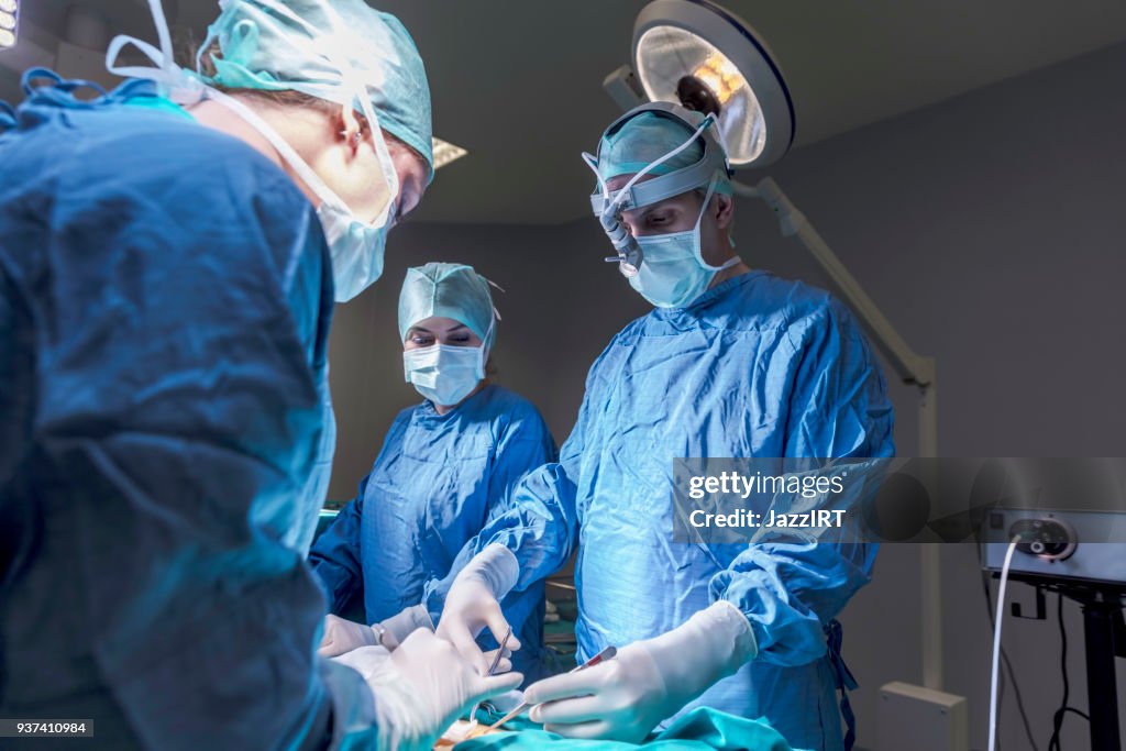 Surgeons in full surgical gear during operation
