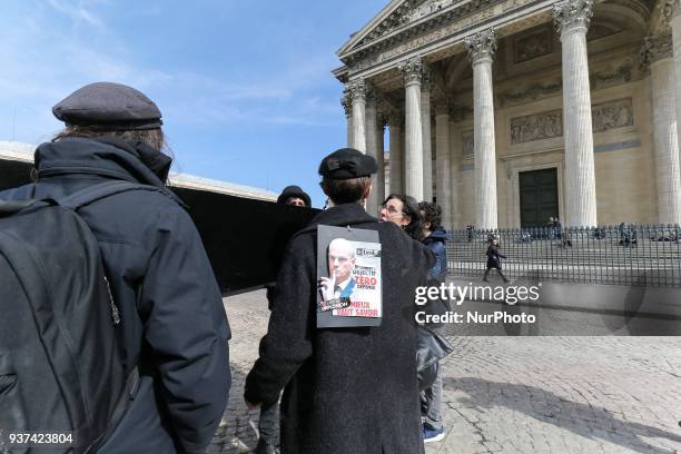 Protester holds a sign against French Education Minister Jean-Michel Blanquer during a demonstration where teachers, parents and students carry a...