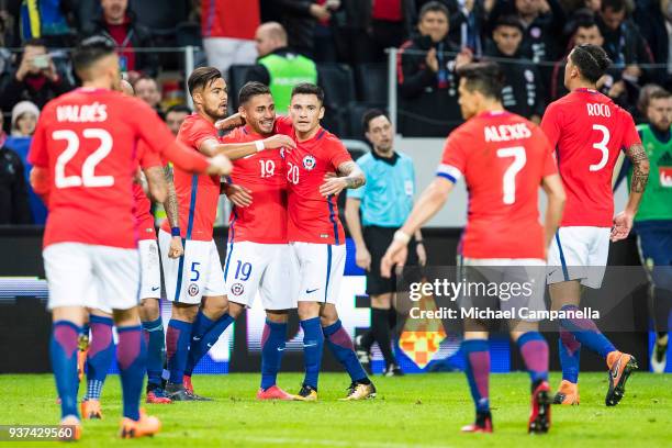 Marcos Bolados of Chile celebrates scoring the 2-1 match winning goal with teammates during an international friendly between Sweden and Chile at...