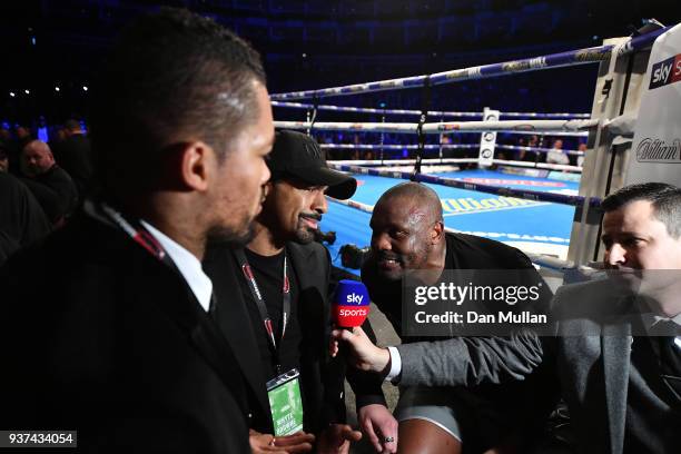 Dereck Chisora of the United Kingdom talks with David Haye and Joe Joyce following victory over Zakaria Azzouzi of France in the Heaveyweight contest...