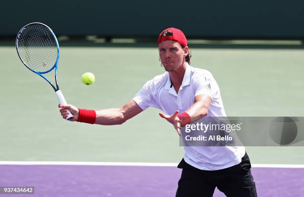 Tomas Berdych of the Czech Republic returns a shot against Yoshishito Nishioka of Japan during Day 6 of the Miami Open at the Crandon Park Tennis...