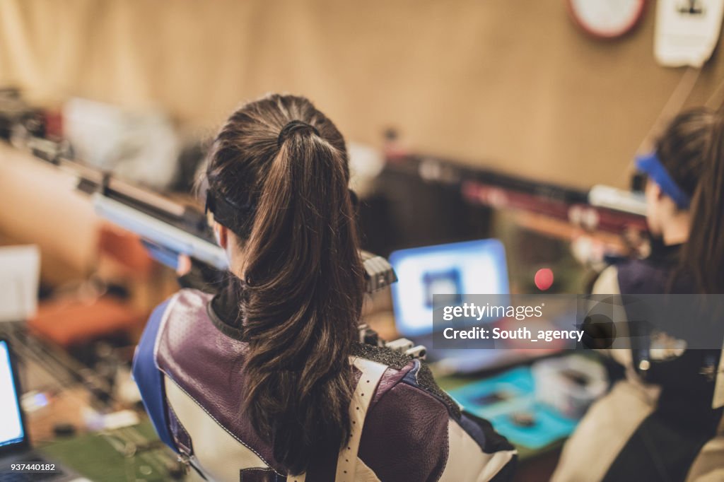 Girls training rifle shooting