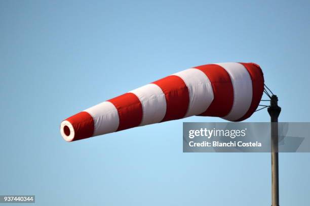 windsock on blue sky - wind fotografías e imágenes de stock