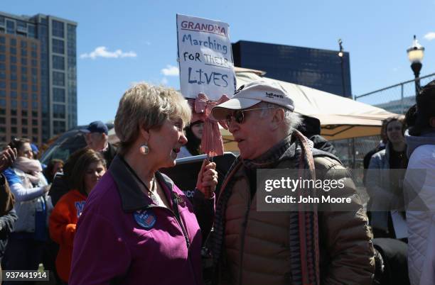 Singer and songwriter Paul Simon speaks to nurse Stephanie Palmeno after Simon sang "The Sound of Silence" at the March for Our Lives rally on March...