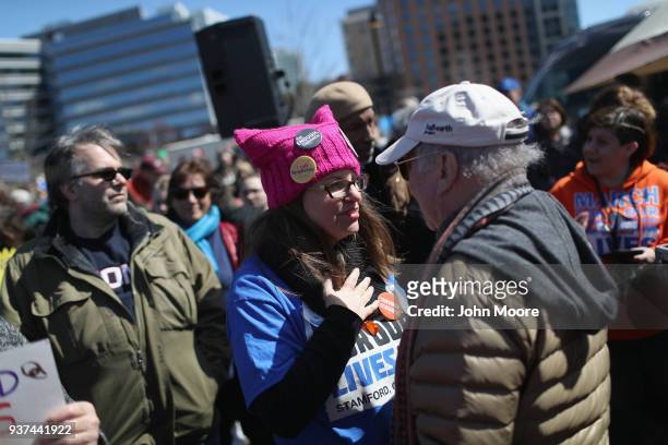 Fellow protester speaks with Paul Simon after Simon sang "The Sound of Silence" at the March for Our Lives rally on March 24, 2018 in Stamford,...