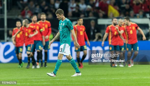 Thomas Mueller of Germany looks dejected as Spain celebrate a goal during the international friendly match between Germany and Spain at Esprit-Arena...