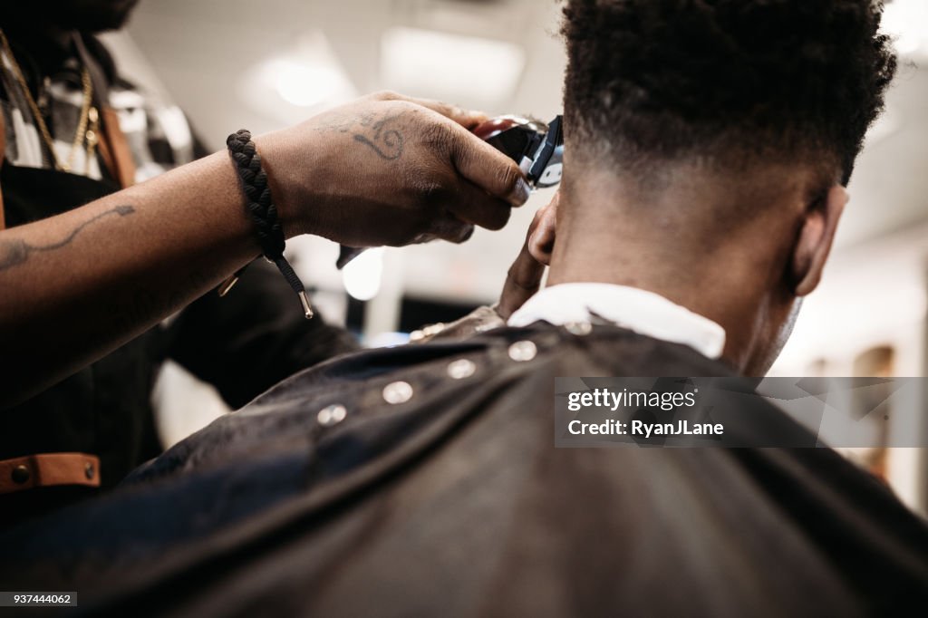 Barber Giving A Haircut in His Shop