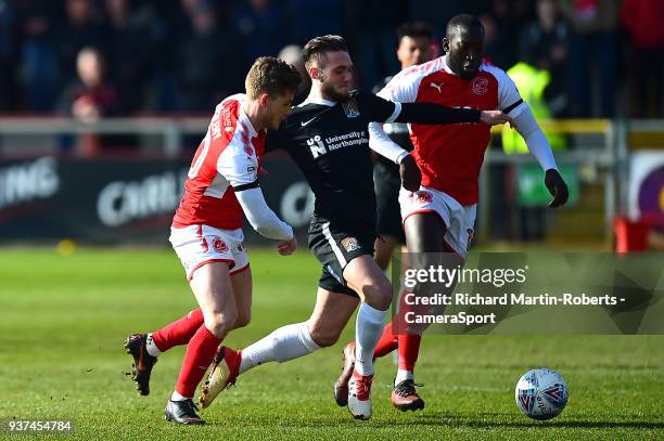 Northampton Town's Matt Grimes competes with Fleetwood Town's Toumani Diagouraga and Conor McAleny during the Sky Bet League One match between...