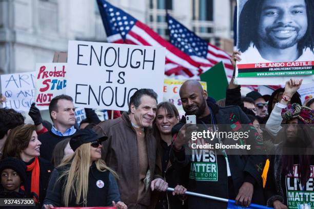 Andrew Cuomo, governor of New York, center, takes a selfie photograph with demonstrators near Central Park during the March For Our Lives in New...