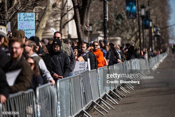 Demonstrators hold signs while gathering on Central Park West during the March For Our Lives in New York, U.S., on March 24, 2018. Thousands of high...