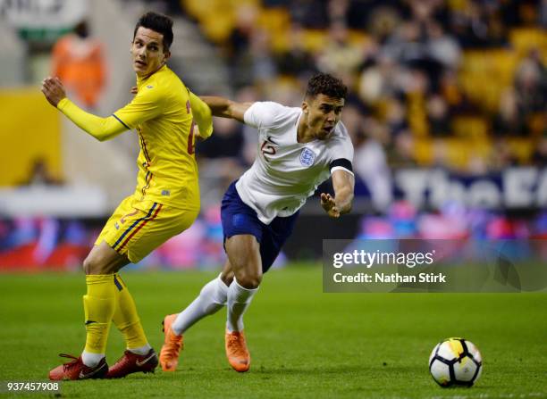 Dominic Calvert-Lewin of England U21 and Vlad Olteanu of Romania U21 in action during the international friendly match between England U21 and...