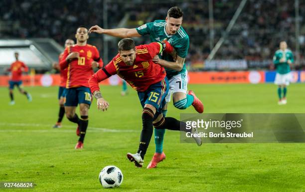 Julian Draxler of Germany challenges Sergio Ramos of Spain during the international friendly match between Germany and Spain at Esprit-Arena on March...